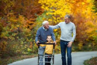 iStock-880854388 elderly father, son and grandson on walk